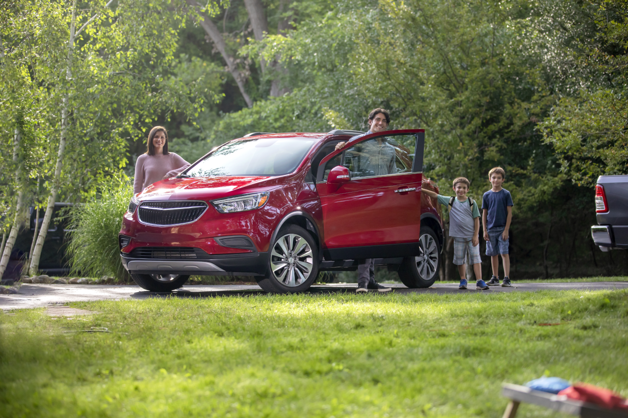 Family with red SUV