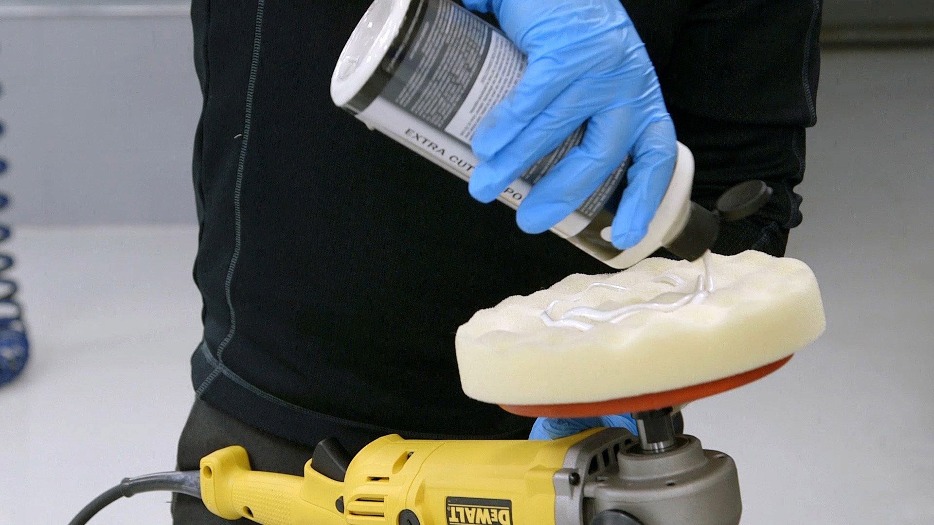 technician removing scratches from a car