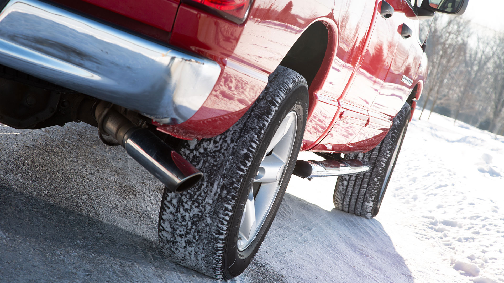 Red truck driving in snow