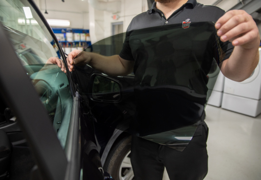 Window tint being put on a car